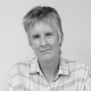 A black and white portrait photograph of the poet in a collared shirt against a white background.