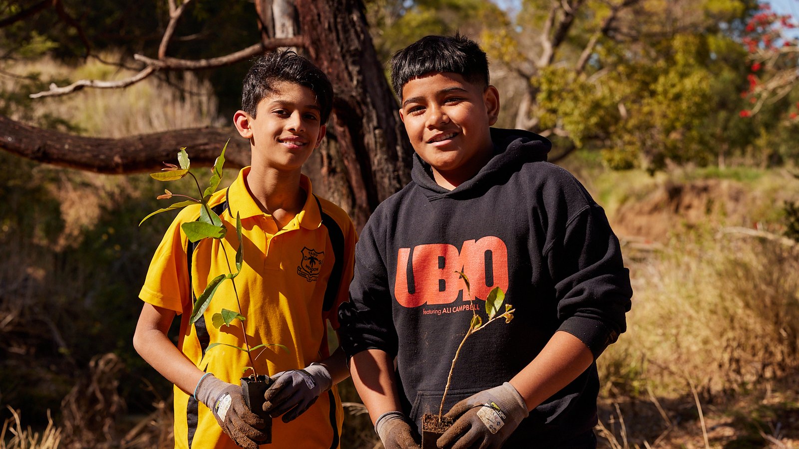 2023_Poem Forest_2 boys holding plant_black tshirt.jpg